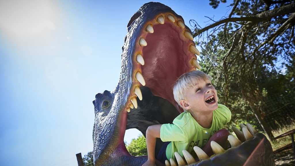 Child in the mouth of a dinosaur